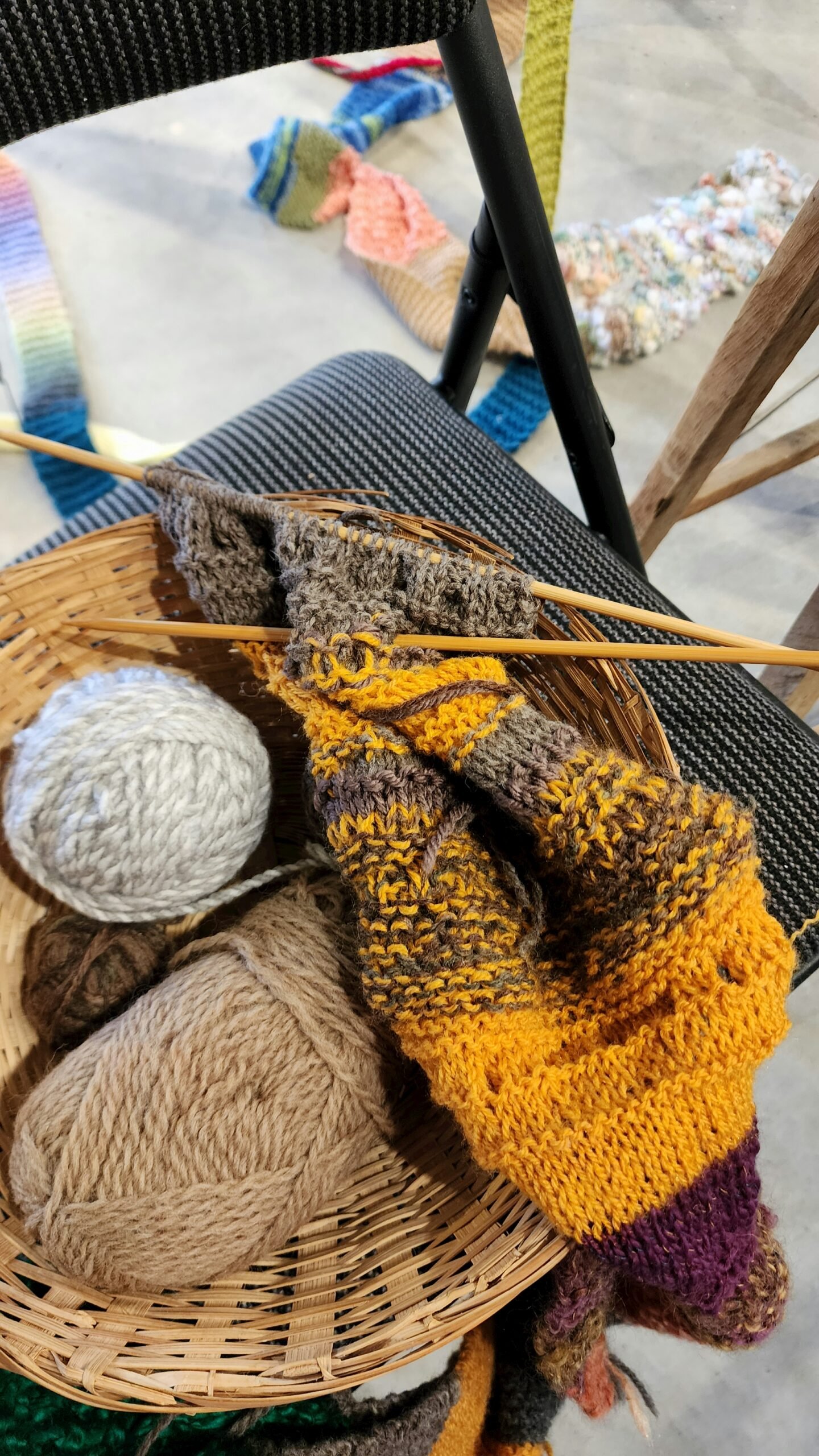 A basket filled with yarn sitting on top of a chair